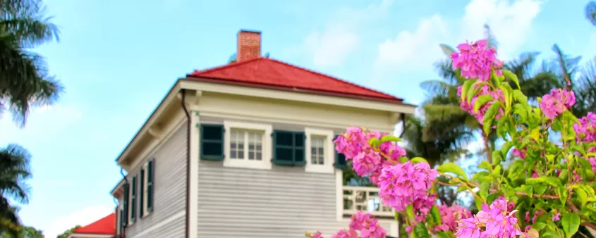 A white house with pink flowers in front of it at Edison & Ford Winter Estates